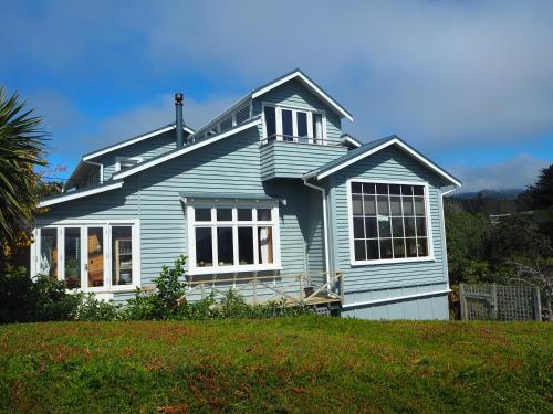 a blue house on top of a hill at Captain Eady's Lookout in Portobello