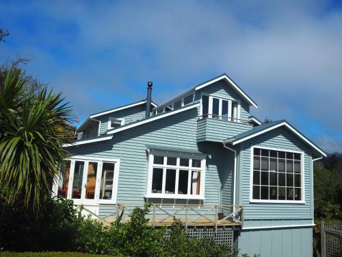 a blue house with a black roof at Captain Eady's Lookout in Portobello
