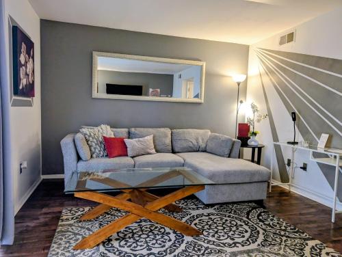 a living room with a couch and a table at Exclusive Townhome - Central Raleigh Location in Raleigh