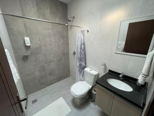 a bathroom with a toilet and a sink and a shower at Nerea-Casa de Playa en Condominio Mar Adentro in Naranjalito