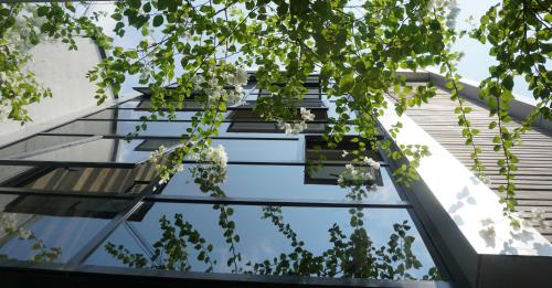 a glass facade of a building with trees at Rockwell Colombo in Colombo