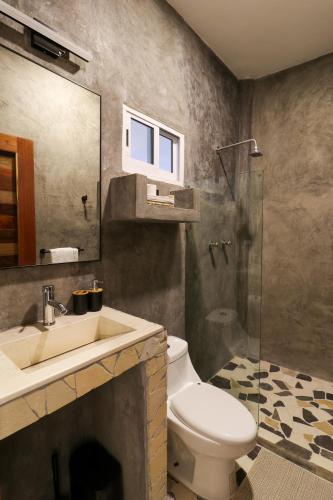 a bathroom with a toilet and a sink and a shower at Casa Pola in Malucano