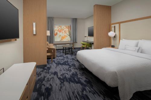 a hotel room with a large bed and a television at Fairfield Inn & Suites by Marriott Miami Airport West/Doral in Miami