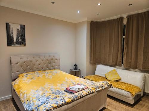 a bedroom with a bed and a couch in it at Private Room Direct Travel Heathrow & Central Ldn in London
