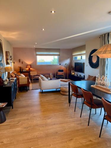 a living room with a couch and a table at Maison à ROSCOFF avec vue mer in Roscoff