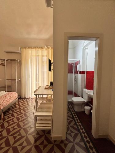a room with a bathroom with a sink and a toilet at Il Teatro Rooms in Catania