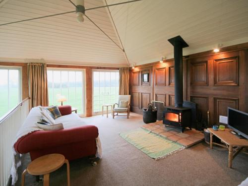 a living room with a couch and a fireplace at Deer Park Lookout - E3928 in Thorpe Market