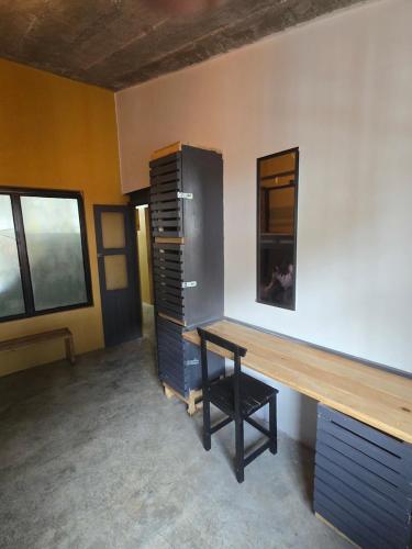 a room with a desk and a cabinet at La Fortaleza Hostel in San Cristóbal de Las Casas