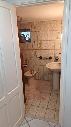 a bathroom with a toilet and a sink at LV SWAN Apartment in Carloforte