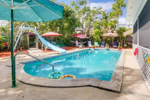 a swimming pool with a slide in a hotel at Sun-Soaked Studio with Pool Access in Lake Worth! in Lake Worth