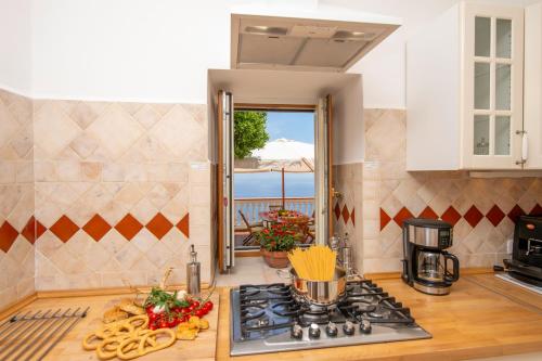 a kitchen with a stove and a counter with food at Oasi Milano in Furore