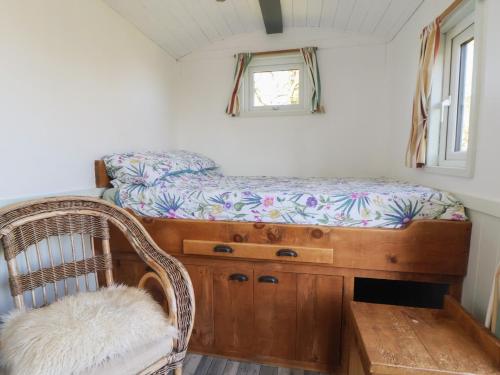 a small room with a bed and a window at Shepherds Delight in Macclesfield