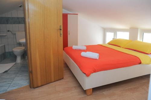 a bedroom with a bed with two towels on it at Golden Coast Villa Caska in Novalja