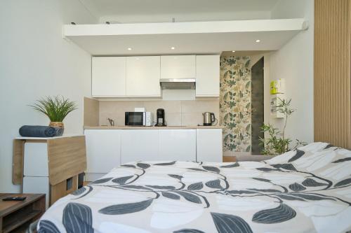 a bedroom with a large bed and a kitchen at Nissa la bella in Nice