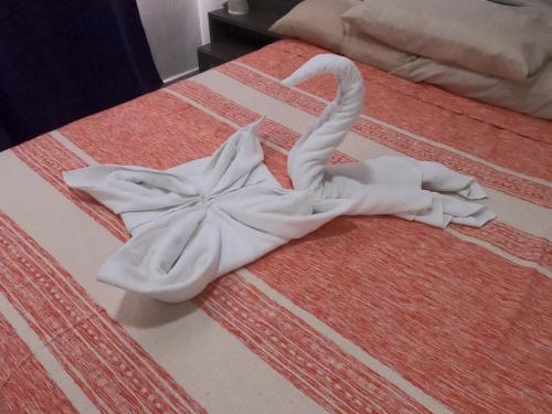 a swan made out of towels on a bed at Casa Atardecer - Privada Los Olivos in Playa del Carmen