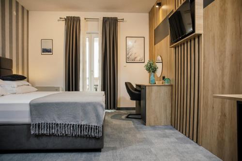 a hotel room with a bed and a desk at White Stone Villa 43 in Promajna