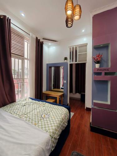 a bedroom with a bed in a room with a window at TANG HOSPITALITY Services in Gisenyi