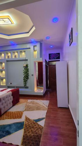 a living room with a couch and a refrigerator at TANG HOSPITALITY Services in Gisenyi