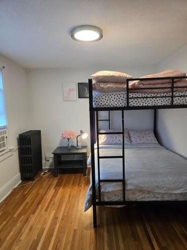 a room with two bunk beds and a desk at Pinkston Gardens in Saint Paul