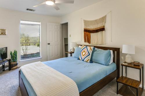 a bedroom with a bed and a window at Infinity Edge Pool & Fire Pit: Spicewood Getaway! in Spicewood
