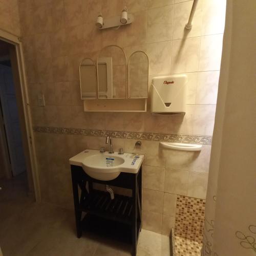 a bathroom with a sink and a mirror at Casa Las Parras in San Rafael