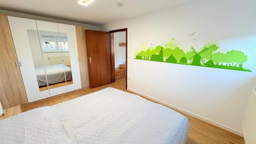 a bedroom with a bed and a wall mural at Lutkistube in Lübben in Lübben