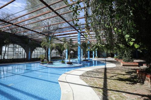 a large swimming pool with a glass roof at Hotel Oviedo Teotihuacán in San Martín de las Pirámides