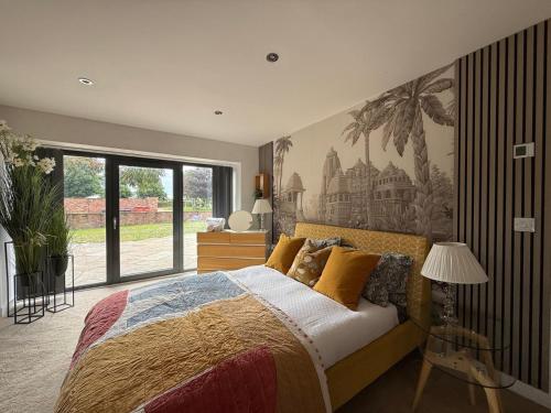 a bedroom with a bed and a painting on the wall at Lincoln 4-Beds Sleeps 13 Hot Tub & Pet Friendly in Lincoln
