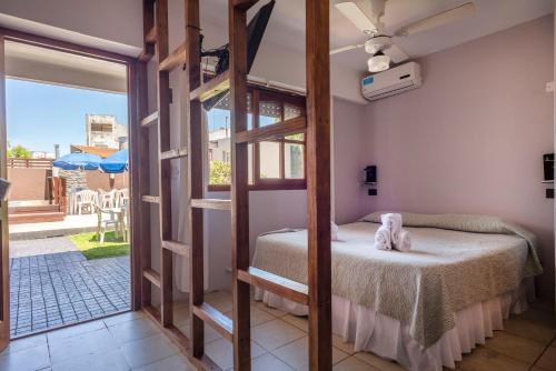 a bedroom with a bunk bed and a open door at Hotel Rideamus in Villa Gesell