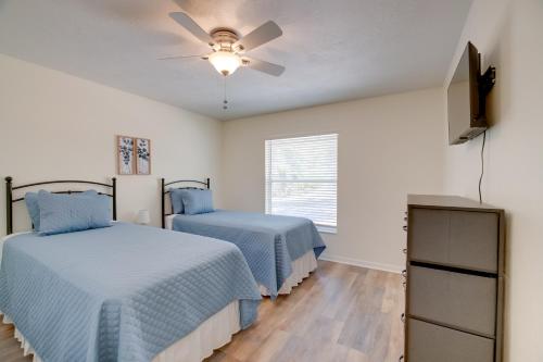 a bedroom with two beds and a ceiling fan at Steps from Crystal River: Crystal River Getaway! in Crystal River