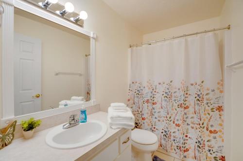 a bathroom with a sink and a shower curtain at Steps from Crystal River: Crystal River Getaway! in Crystal River