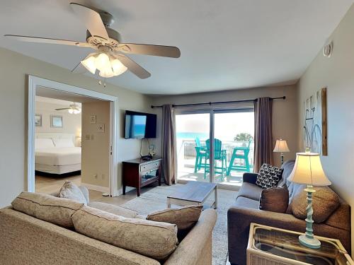 a living room with a couch and a ceiling fan at Regency Towers #302 West in Pensacola Beach