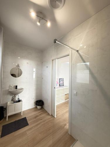a bathroom with a glass shower and a sink at Casa Ángel 1982 in Oia