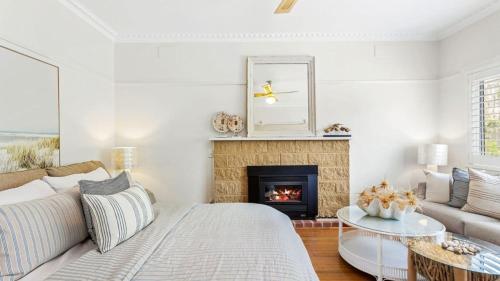 a living room with a couch and a fireplace at Waves on Rye in Rye