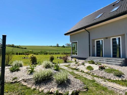 a house with a garden in front of it at Polny Domek in Bystrzyca Kłodzka