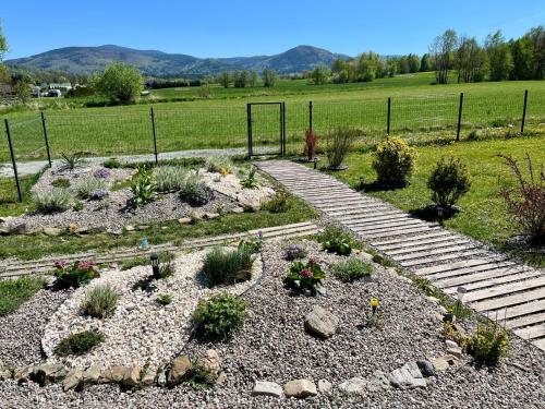 a garden with stairs and plants in a field at Polny Domek in Bystrzyca Kłodzka