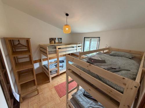a bedroom with a bunk bed and a desk at Algarve Surf Hostel & Guest House in Raposeira