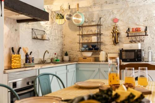a kitchen with a wooden table and a table sidx sidx at Casinha da Vereda by Rent-a-key in Paul do Mar