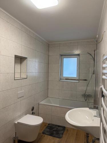 a bathroom with a tub and a sink and a toilet at Luxury Comfort Home in Anklam