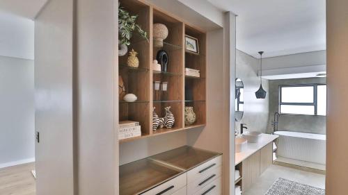a bathroom with wooden cabinets and a sink at Pops lifestyle in Sandton