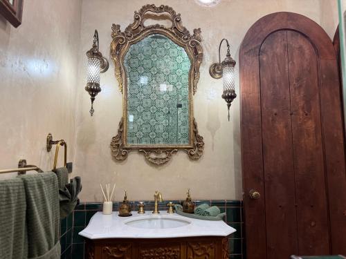 a bathroom with a sink and a mirror on the wall at Riad Xula Boutique Hotel in Puerto Peñasco