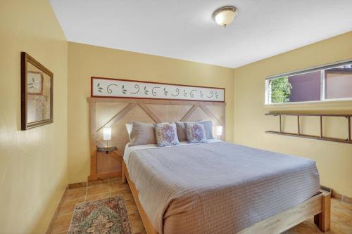a bedroom with a bed and a window at Creekside Juanita's Place - 51 E 200 in Moab