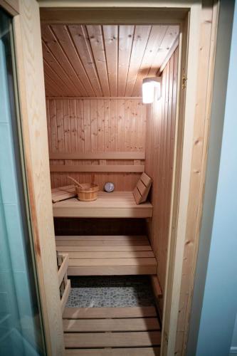 a wooden sauna with a bench in it at Marée Mason in Ocean Springs