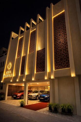 a hotel with cars parked outside of it at night at Liza Royale Hotel Near Chennai central Railway Station in Chennai