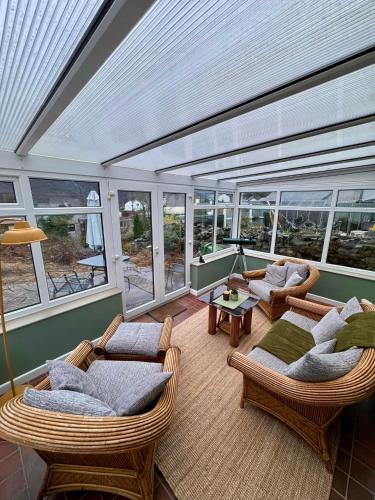a room with wicker chairs and couches on a house at House in Llanberis in Llanberis