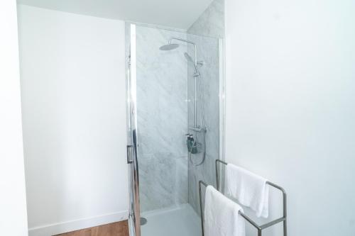 a bathroom with a shower and a toilet at Spacious 4-bedroom - 2 full Bathrooms home - Private off-road Parking - Centrally located in Bridgend