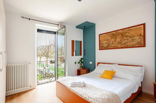a bedroom with a bed and a large window at SYC I Mulini, Leonardo Academy & MXP & JRC Ispra in Sesto Calende