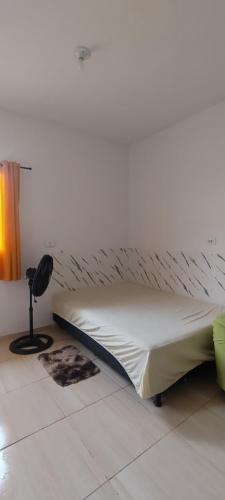 a bedroom with a bed and a lamp on the floor at Kitnet na Imbiribeira in Recife