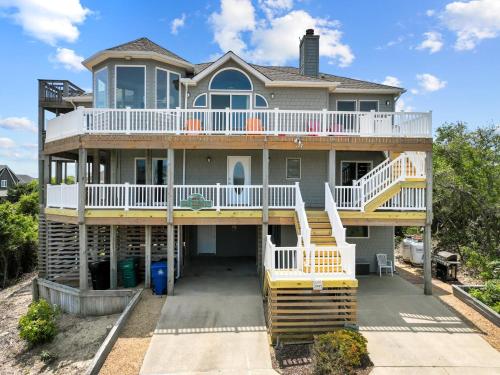 a large house with a wrap around deck at 3945 - Sea Lodge II in Duck
