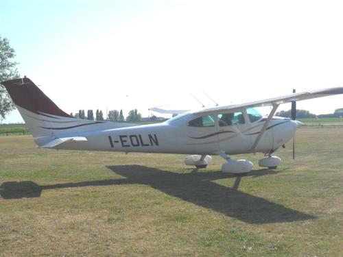 a small plane sitting on the grass in a field at Hotel Rurale Canneviè in Lido di Volano